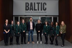 Pupils, teachers and artists stood in a row in front of the Baltic entrance sign