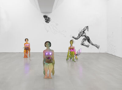 An exhibition with three models of people,