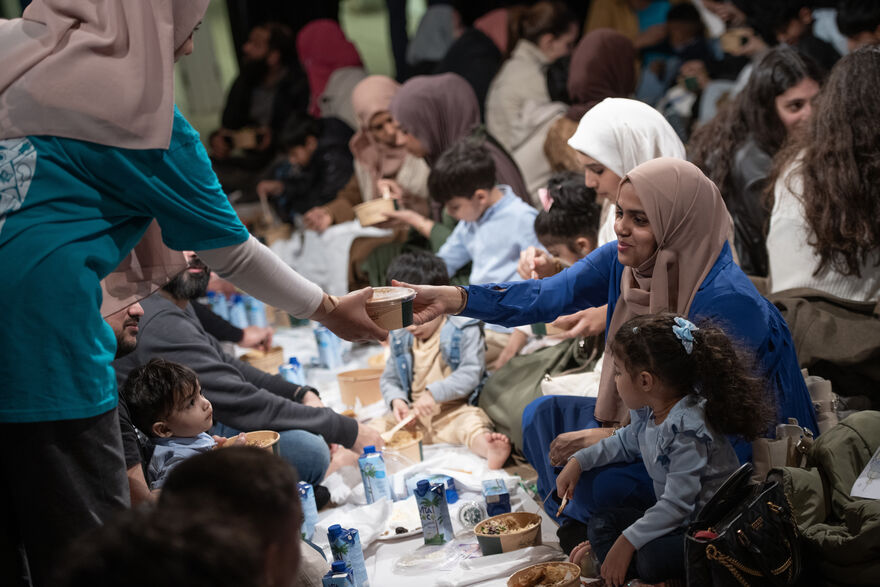 People sat together sharing a meal.