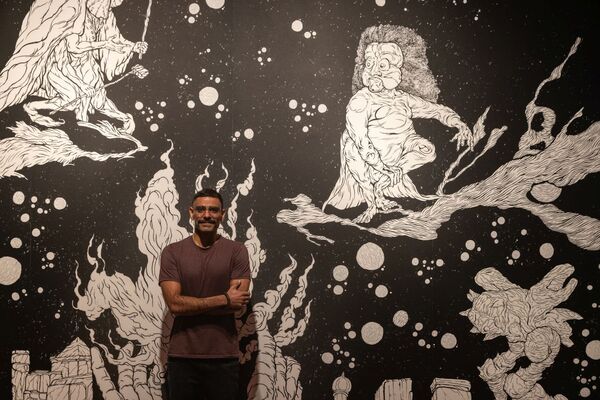 Artist Sahej Rahal stood in front of his artwork