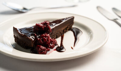 Chocolate torte presented on a white plate.
