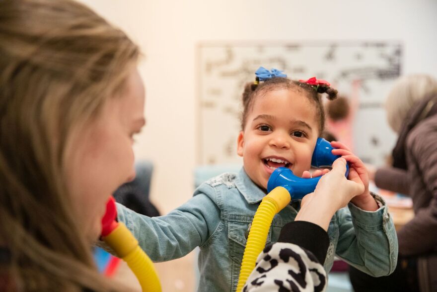 child using a toy telephone