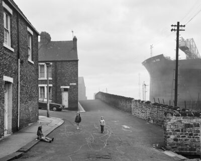 black and white photograph of children playing in the street.