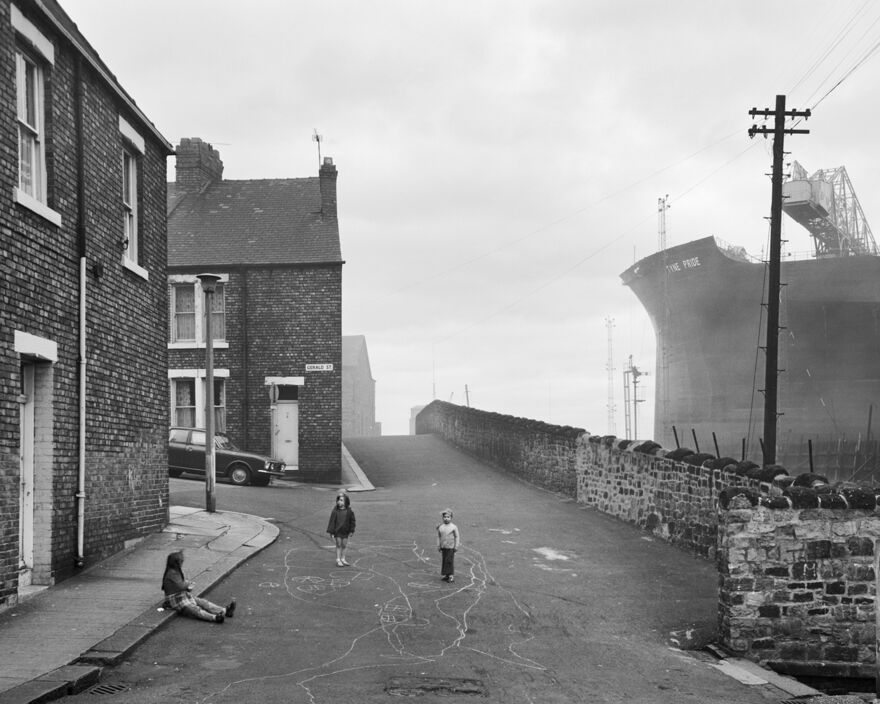 black and white photograph of children playing in the street.