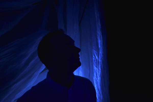 Side profile self portrait of Steve Ronnie in dark blue sillhouette