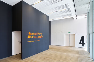 A dark blue gallery entrance with Hannah Perry Manual Labour written on it