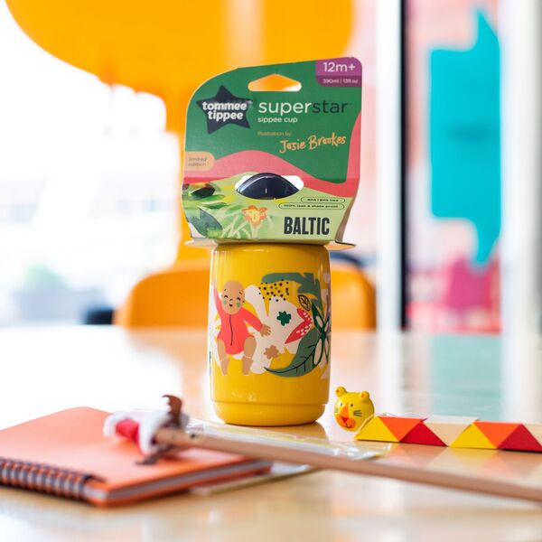 Yellow sippee cup with illustrated baby on the front