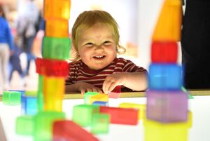 Child smiling playing with blocks