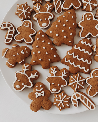 Plate of gingerbread biscuits decorated with white icing