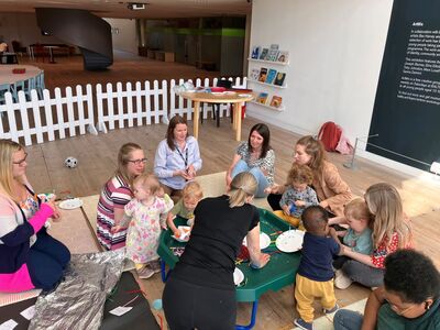 Adults and children sat altogether crafting