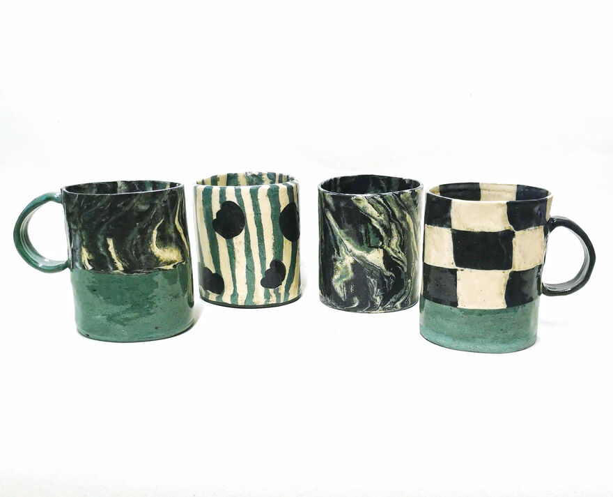 Four handmade mugs of different patterns