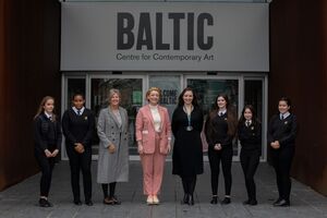 Teachers and pupils stood in front of Baltic entrance sign