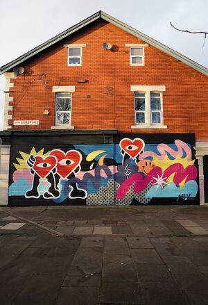 Shop shutters with artwork including red hearts and colourful lines