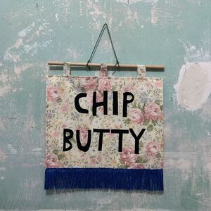 Floral wall hanging with text 'Chip Butty'