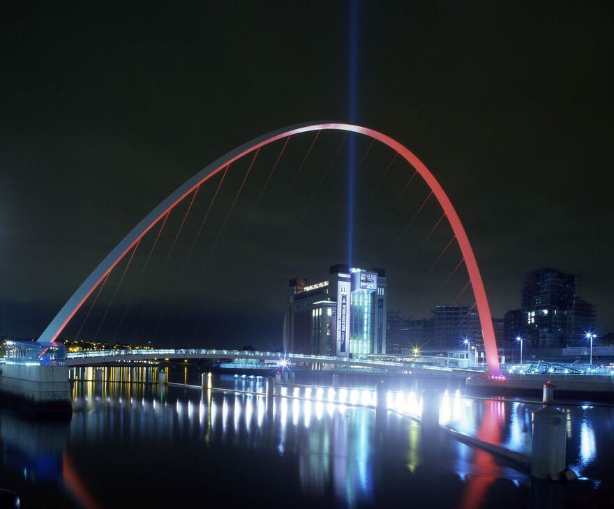Quayside at night with light beam from Baltic