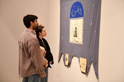 Visitors looking at exhibition artwork