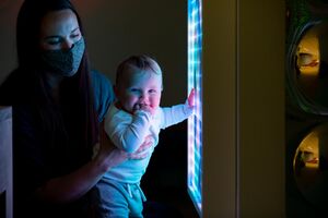 Person with baby enjoying sensory room
