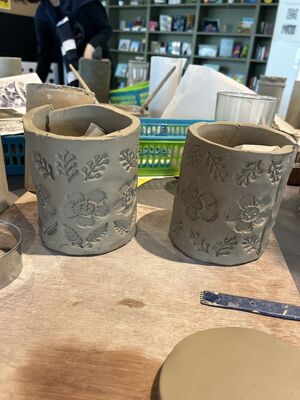 Two clay pots with flower and leaf detail