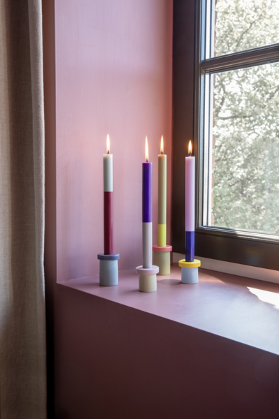 Colourful candles in colourful holders.