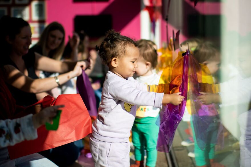 Child holding paper to window