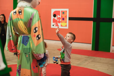Child waving within an exhibition