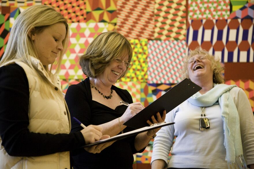 People with clipboards laughing