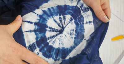 An white cloth dyed with an intricate blue pattern