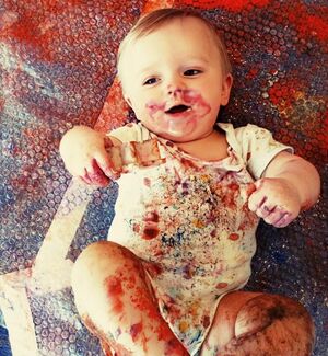 Young child playing with paint