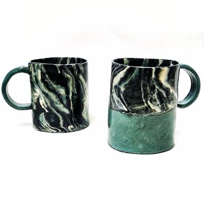 Two marble-effect handmade mugs.