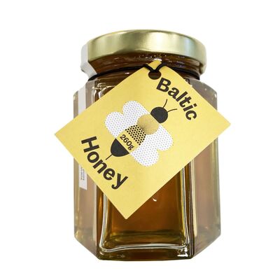Jar of honey with yellow label with Bee, and 'Baltic Honey'