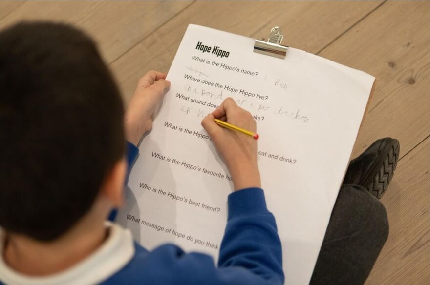 Child filling out learning resource