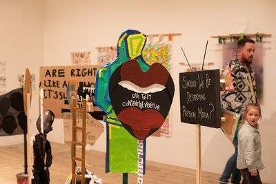 Visitors looking at exhibition artwork