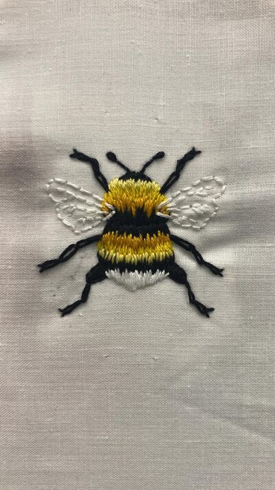 Embroidered bee on fabric
