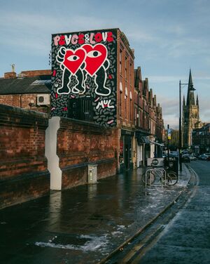 View down street with artwork of two hearts and text, peace & love