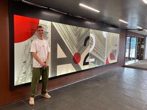 Artist Joe Seymour stood in front of artwork