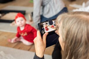 Adult taking photo of children with phone