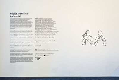 A white wall with two columns of text on the left and two outlines of drawings of 