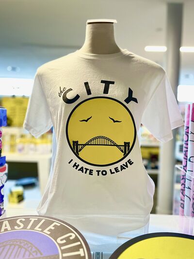 A Newcastle-themed t-shirt reads 'the city that I hate to leave'.