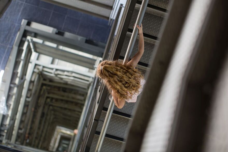 Girl looking down stairwell