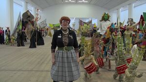 Crew member Sophie with Hew Locke Procession behind